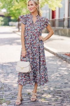 This floral midi dress is so chic! That tiered body is so flowy which makes it super comfy! The fluttery sleeves are super cute too! This dress looks great with heels, booties, or mules! Partial button down v-neckline Ruffled cap sleeves Ditsy floral print No stretch Baileigh is wearing the small. Flowy Mid-length Dress With Ditsy Floral Print, Modest Knee-length Midi Dress With Ditsy Floral Print, Red Midi Dress With Ditsy Floral Print, Flowy V-neck Midi Dress With Ditsy Floral Print, Elegant Ditsy Floral Print V-neck Midi Dress, Just For Today, Ditsy Floral Print, Mint Julep Boutique, Navy Floral