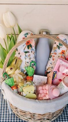 a basket filled with lots of different items on top of a blue and white checkered table