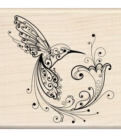 a rubber stamp with a bird and swirls on the wings, in black ink