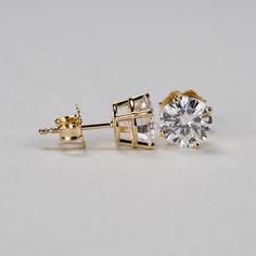 Our 4-prong round Charles & Colvard Forever One® colorless moissanite stud earrings are the perfect addition to your jewelry collection. Get the look and durability of diamonds, without the high cost and environmental footprint. Available in 14k, 18k yellow, white and rose gold as well as platinum. Choose desired metal and stone size from the drop-down menus before checkout. If you want these made with GIA certified diamonds, colored gemstones, or different moissanite shapes, please contact Gia Certified Round Lab Grown Diamond Earrings, Gift Earrings With Lab Grown Diamonds And Prong Setting, Gift Earrings With Prong Set Lab Grown Diamonds, Minimalist Moissanite Round Cut Earrings, Yellow Gold Moissanite Diamond Earrings, Moissanite Yellow Gold Round Diamond Earrings, Gold Solitaire Round Earrings, Timeless Moissanite Earrings With Prong Setting, Gold Lab-grown Diamond Round Cut Earrings