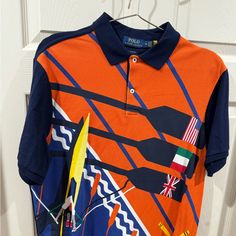 Brand New Without Tags. This Shirt Has Traveled From New York To San Juan Puerto Rico But Never Worn. Tags Removed For Trip Because I Was Going To Use It But It Was Too Hot To Wear It. Classic Fit M (Really A Large) Orange Graphic Print Collared Tops, Multicolor Polo Collar Top With Graphic Print, Multicolor Graphic Print Polo Collar Top, Multicolor Graphic Print Top With Polo Collar, Fitted Orange Collared Top, Fitted Collared Orange Top, Fitted Multicolor Polo Collar Shirt, Orange Collared Shirt With Graphic Print, Orange Collared Cotton Top