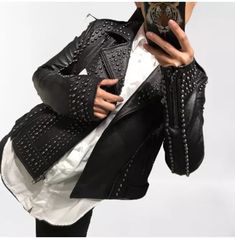 Introducing our Punk Women Black Leather Studded Jacket, the epitome of edgy and rebellious rock biker fashion. Crafted with meticulous attention to detail, this jacket is a must-have for any fashion-forward individual looking to make a bold statement. Constructed from high-quality leather, this jacket is designed to withstand the test of time, ensuring both durability and style. The genuine sheepskin shell exudes a luxurious feel, while the soft cotton and silk mix fabric lining provides superior comfort and breathability. Featuring a front zip fastening, this jacket effortlessly combines functionality with style. The zip closure allows for easy wear and adds a touch of modernity to the classic biker jacket design. Two side pockets provide ample storage space for your essentials, while an Indie Scene Style, Rocker Chic Style, Biker Fashion, Rocker Look, Punk Women, Leather Jacket Women, Studded Leather Jacket, Studded Jacket, Scene Fashion