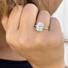 a close up of a person's hand with a ring on their finger