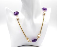 Necklace jewelry.  Amethyst and pearl Necklace with gold chain.  Handmade gemstone and gold bead caps on long necklace jewelry. Anniversary, birthday and graduation necklace jewelry.  An ideal gift for her. MATERIALS AND SIZE 20mm amethyst coin shape beads 10mm and 88mm white shell pearl beads 18k gold over stainless steel oval linked chain 18k gold over stainless steel jump rings 18k gold over stainless steel lobster claw clasp Gold wire bead caps (handmade) Necklace measures - -41 inches in length    Can be worn long as is or worn doubled up.   Fit for any occasion. Elegant Chain Necklace With Natural Stones As Gift, Gold Pearl Necklace With Gemstone For Gift, Gold Pearl Chain Necklace For Gift, Party Necklaces With Natural Stones In Gold, Elegant Gold Amethyst Crystal Necklaces, Pearl Single Strand Long Necklace As Gift, Gold Necklaces With Natural Stones For Party, Gold Beaded Necklace With Pearl Chain For Anniversary, Long Necklace With Round Pearl Beads For Gift