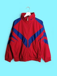 Vintage 90's soft shell track jacket, branded with huge taekwando logo on back. Beautiful cut, bright red and blue colour scheme. Brand BERRI, made in Denmark. Very good vintage condition, no flaws! Would fit size XS-M, depending on build and desired fit. Size tag reads (men's) S. Please read the measurements carefully and compare to one of your own garments to avoid any disappointment regarding the fit. Measurements of the item, laying flat: - chest (armpit to armpit): 64 cm; - length (nape to Red Casual Windbreaker For Sports Events, Casual Red Windbreaker For Sports Events, Red Sportswear Track Jacket For Sports Events, Red Track Jacket For Sports Events, Red Throwback Outerwear For Sports Events, Red Track Jacket For Sports Season, Red Track Jacket For Sports Season Outdoors, Red Track Jacket For Outdoor Sports Season, Sporty Red Track Jacket For Athletic Season