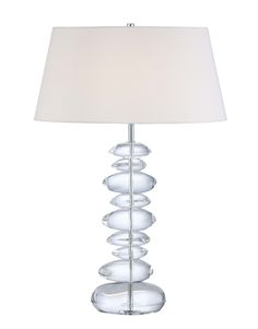 a glass lamp with a white shade on it