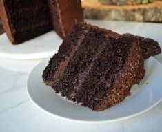 two slices of chocolate cake on white plates