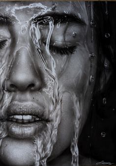 a woman's face is covered in water