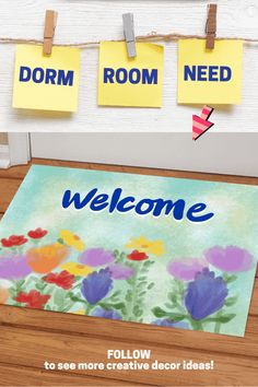 a welcome mat is hanging on a wall with sticky notes attached to it and the words welcome written below