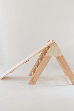 a small wooden structure sitting on top of a white floor