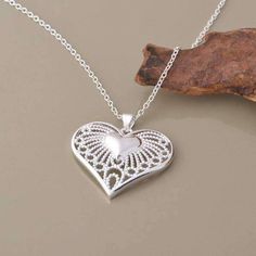 One heart is never enough. Show twice the love with this necklace. One small silver heart is just bursting out to the larger heart with delicate filigree tendrils. Shining in sterling silver and a true testament of love! Includes 18 in. chain Material: Silver plating over copper Size: 30mmx30mm Comes in a gift box for easy gift giving (Reg $35.99) Delicate Heart Shaped Silver Jewelry, Delicate Silver Heart Jewelry, Delicate Silver Heart Pendant Necklace, Elegant Filigree Heart Necklace, Elegant Heart-shaped Filigree Necklace, Elegant Heart Shaped Filigree Necklace, Delicate Open Heart Silver Jewelry, Delicate Silver Open Heart Jewelry, Elegant Nickel-free Heart Necklace