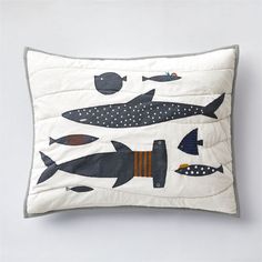 an embroidered pillow with fish on it