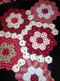 several hexagons are laid out on the table to be sewn together