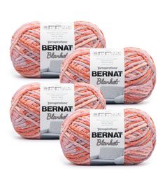 three balls of yarn with the label bernat blends on them in pink and orange