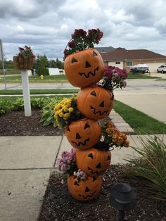 a stack of pumpkins sitting on top of a flower pot