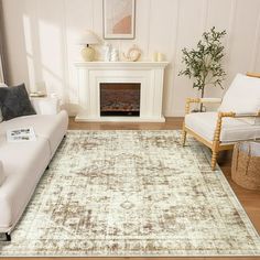 a living room with white couches and a large rug on the floor in front of a fireplace