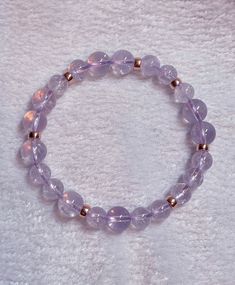 "Natural Lavender Milky Amethyst from Brazil in soft pastel color and high crystal briliance. Calming, soothing yet also invokes positive thoughts in the wearer. Increases the attractiveness and \"glow\" of the wearer. Can be worn for invoking peaceful sleep and meditation. Inserts are 14k 🌹 rose gold filled made in Italy. Length of bracelet: 7.5 inches Diameter of Milky Lavender Amethyst beads: 9.4mm & 7.5mm Pls contact seller for details. The length of the bracelet can be changed to the s Healing Lavender Crystal Bracelet With Gemstones, Purple Rose Quartz Round Jewelry, Round Purple Rose Quartz Jewelry, Lavender Crystal Bracelet With Adjustable Fit, Adjustable Lavender Crystal Bracelet, Faceted Amethyst Crystal Bracelet For Healing, Elegant Hypoallergenic Crystal Bracelet For Healing, Pink Amethyst Crystal Bracelet For Healing, Adjustable Lavender Crystal Bracelet For Healing