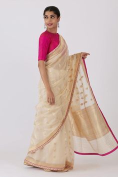 Rich cream saree with floral motif,  aari and zardosi embroidery. Comes with 2 unstitched blouse piece.
Components: 3
Pattern: Embroidered
Type Of Work: Floral
Fabric: Silk Cotton
Color: Cream
Other Details: 
Embroidered border
Note: The stitched blouse worn by the model is not for sale
Occasion: Puja - Aza Fashions Navratri Slub Silk Pre-draped Saree, Unstitched Pre-draped Tissue Silk Saree, Transitional Season Sheer Dupatta Saree, Tissue Silk Pre-draped Saree For Navratri, Traditional Silk Pre-draped Saree, Slub Silk Saree With Detailed Pallu, Slub Silk Choli With Pallu, Sheer Dupatta Cotton Silk Choli, Pre-draped Chanderi Saree With Unstitched Blouse