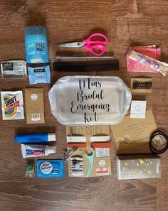 the contents of a bride's emergency kit laid out on a wooden table, including scissors and other items