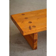 a wooden bench with holes in the wood