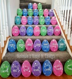 colorful easter eggs are lined up on the stairs for children's birthday party decorations