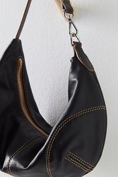 So chic in a crescent-shaped silhouette, this slouchy bag is featured in a soft leather fabrication and unstructured design with a top-zip closure and fixed shoulder strap. **Features:** Soft leather fabrication with silk-lined interior, slouchy crescent shape, contrast seaming, top-zip closure, fixed shoulder strap **Why We ❤ It:** The perfect goes-with-everything bag, this is one you’ll be reaching for again and again. | Real World Clutch Bag by FP Collection at Free People in Black Cheap Trendy Top Handle Hobo Bag, Luxury Top Handle Hobo Bag For Fall, Cheap Chic Hobo Bag With Single Shoulder Strap, Cheap Trendy Hobo Shoulder Bag, Luxury Fall Hobo Bag With Top Handle, Cheap Trendy Faux Leather Hobo Bag, Luxury Hobo Pouch Bag With Top Carry Handle, Luxury Hobo Bag Satchel With Leather Trim, Free People Leather