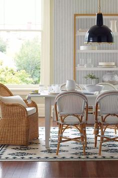 the dining room table is set with four chairs