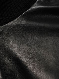 leather bomber jacket from Gucci featuring black, lambskin, embossed logo to the rear, ribbed band collar, front zip fastening, long sleeves, two side zip-fastening pockets, elasticated cuffs and elasticated hem. This item is in size 48 and the color is Luxury Leather Outerwear With Ribbed Cuffs, Black Leather Jacket With Ribbed Collar, Classic Black Gucci Outerwear, Gucci Luxury Leather Jacket For Winter, Gucci Leather, Band Collar, Embossed Logo, Side Zip, Bomber Jacket