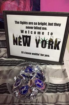 there are chocolate candies in a bowl on the table with a sign behind it