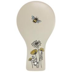 a white vase with flowers and bees on it