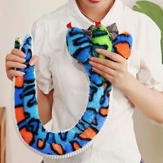 a young boy is holding a colorful animal ring