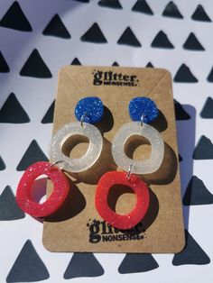 Red, white & blue earrings, Ideal for the Kings Coronation, show some patriotic pride in these limited edition statement earrings. These earrings are big and bold, but still very light and comfortable to wear. They make a statement with their triple drop and the pop of colourful glitter. 🌟 Hand-mixed, hand-poured resin 🌟 Stainless steel earring back posts with stainless steel butterflies 🌟 Custom glitter mix - please note this is NOT my usual biodegradable glitter 🌟 No two pairs are alike De Patriotic Blue Earrings For Party, Blue Patriotic Earrings For Independence Day, Patriotic Blue Earrings For Independence Day, Red Patriotic Jewelry For Party, Patriotic Red Jewelry For Party, Red Jewelry For 4th Of July Party, Red Jewelry For Party On 4th Of July, Patriotic Drop Earrings Jewelry Gift, Red Dangle Earrings For 4th Of July