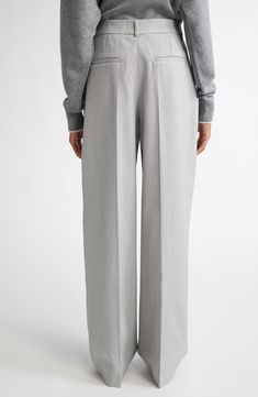 Pleat-front pants predominate in the Jacquemus fall '24 collection, bringing classic yet relaxed tailoring to the fore, as with this pair in a loose-fitting, mid-rise cut from a wool-enriched-blend suiting fabric. 34 1/2" inseam; 19 1/2" leg opening; 12 1/4" front rise; 15 1/2" back rise (size 6US/38FR) Zip fly with hook-and-bar closure Side-seam pockets; back welt pockets 35% polyester, 34% cotton, 29% virgin wool, 2% elastane Dry clean Imported Designer Clothing Timeless Semi-formal Wide Leg Bottoms, Timeless Straight Leg Pantsuit For Business Casual, Tailored Straight Leg Timeless Pantsuit, Tailored Straight Leg Pantsuit In Timeless Style, Tailored Timeless Straight Leg Pantsuit, Timeless Straight Leg Office Pantsuit, Timeless Wide Leg Workwear Pants, Formal Wool Wide Leg Pants For Spring, Classic Wide-leg Pantsuit