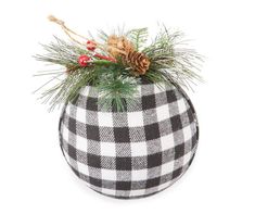 a black and white checkered potted planter with pine cones, berries and evergreen needles