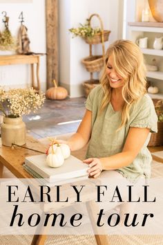 a woman sitting at a table in front of a book with the words, early fall home tour