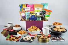 an assortment of snacks and coffee on a table