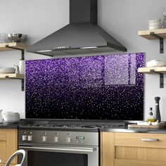 a stove top oven sitting inside of a kitchen under a purple rain droplet wall