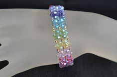 Crystal, crystal bracelet, women's cuff, rainbow, fashion accessory, luxury, chakra For good vibes, harmonious colors Width : 1.5 cm Length: 18.5 cm or other Clasp 3 rows rhinestone Crystal 13 mm plated rhodium You can ask me the length that you wish in order to adapt it perfectly to your wrist.  Material: crystal, rocailles, clasp in rodhium guaranteed without nickel Crystal is glass with a refractive index of 1.545 or higher. Unlike glass, crystal has more clarity, more brightness. Elegant Rainbow Bracelets With Round Beads, Elegant Rainbow Beaded Bracelets, Elegant Rainbow Bracelets For Parties, Elegant Rainbow Round Beads Bracelet, Elegant Multicolor Crystal Bracelet, Elegant Adjustable Rainbow Beaded Bracelets, Multicolor Crystal Bangle Bracelet, Multicolor Crystal Jubilee Bracelet, Multicolor Crystal Bracelet Jewelry