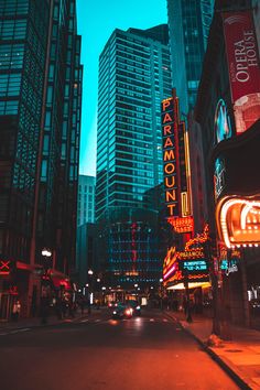 a city street filled with tall buildings and neon signs