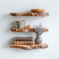 two wooden shelves with books and vases on them