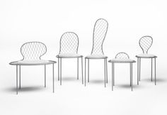 four white chairs sitting next to each other