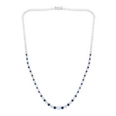 This blue lab-created sapphire and diamond tennis necklace radiates alluring beauty and classic style. 10K white gold Alternating diamonds and blue lab-created sapphires graduate in size to the largest 1/5 ct. diamond at the center 1-1/2 cts. t.w. of diamonds 16.0-inch necklace; box clasp Classic Diamond Tennis Necklace With Gemstones, Classic Blue Diamond Necklace With 17 Jewels, Formal White Gold Tennis Necklace With Gemstone, Classic Sapphire Diamond Necklace For Formal Occasions, Classic Sapphire Necklace For Formal Occasions, Classic Formal Sapphire Diamond Necklace, Formal Cubic Zirconia Tennis Necklace With Gemstones, Classic Blue Diamond Necklace With Accents, Classic Blue Diamond Necklace With Diamond Cut