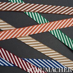 six different colored striped ties on a gray surface with the words summer written below them