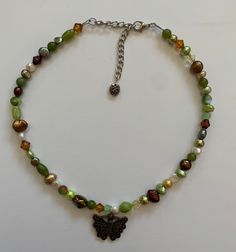 Handmade with freshwater pearls, glass beads, brass charm and stainless steel components Art Mom Aesthetic, Jewellery Wishlist, Green Bead Necklace, Art Mom, Mom Aesthetic, Beaded Stuff, Crystal Pearl Earrings, Earthy Jewelry, Green Beaded Necklace