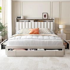 a white bed sitting in a bedroom on top of a carpeted floor next to a window