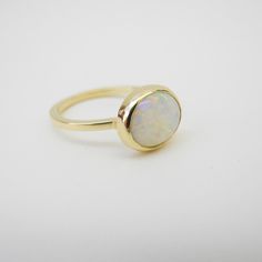 Modern 14k Gold Opal Ring, Modern Round Promise Ring, Timeless White Stackable Jewelry, Modern 14k Gold Opal Ring With Polished Finish, Modern Opal Ring In 14k Gold With Polished Finish, 14k Gold Ring With Polished Round Stone, 14k Gold Rings With Polished Round Stone, 14k Gold Rings With Polished Finish And Round Stone, White Bezel Set Round Cut Ring