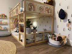 a child's bedroom with a bunk bed and stuffed animals on the floor next to it