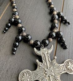 This beautiful, one-of-a-kind pewter ornate cross necklace will inspire all your moonlit nights. Handmade with black agate and glass beads. Measures 18 inches long and has a 2 inch extender chain. product details silver tone metals; Cross is soft pewter. 18 inches long with 2 inch extender black agate and glass beads VISIT MY SHOPS HERE * http://www.etsy.com/shop/HappyCatHouse * http://www.Etsy.com/shop/AnEnchantingCreature CONNECT * http://www.facebook.com/EnchantingCreature * https://www.insta Black Adjustable Crucifix Necklace, Adjustable Black Crucifix Necklace, Silver Cross Jewelry With Black Beads, Adjustable Cross Necklace With Black Beads, Adjustable Black Beads Cross Necklace, Gothic Cross Necklace For Festivals, Gothic Black Metal Cross Necklace, Gothic Black Cross Pendant Necklace, Adjustable Gothic Cross Pendant Jewelry