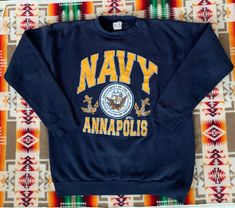 Vintage 80s/90s US Navy sweatshirt. Made in the USA by Tultex. 50/50 cotton poly blend. In good vintage condition. No holes, small stain on the front shown in photos. Size marked XL but please refer to the actual measurements: 22 inches from pit to pit measured lying flat, 20 inches across the shoulders, sleeve length is 22 inches and the overall length is 26 inches. Please view all photos, measurements and descriptions before purchasing. Please feel free to ask questions. All sales final. Navy Blue Vintage Nike Sweatshirt, Vintage Pre-shrunk Sweatshirt For Fan Merchandise, Vintage Pre-shrunk Sweatshirt For Fans, Pre-shrunk Vintage Sweatshirt For Fans, Us Navy Sweatshirt, Vintage College Sweatshirts, Navy Sweatshirt, Fringe Leather Jacket, Blue Crewneck