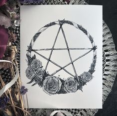 a pentagramil with roses in it on a doily